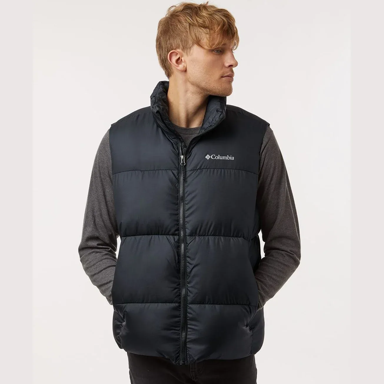 Men's Puffect III Vest displayed in a stylish outdoor setting